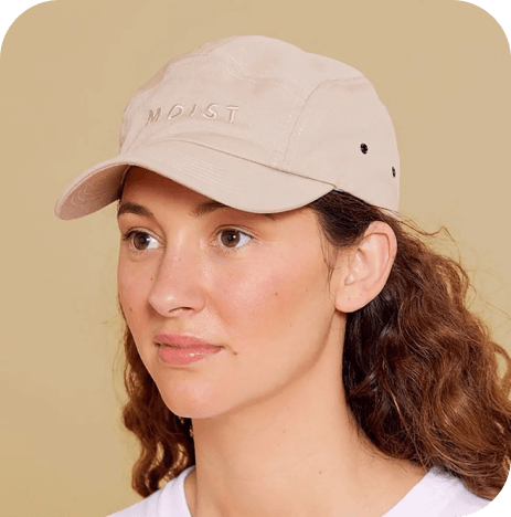 An image featuring a woman wearing a promotional cap.